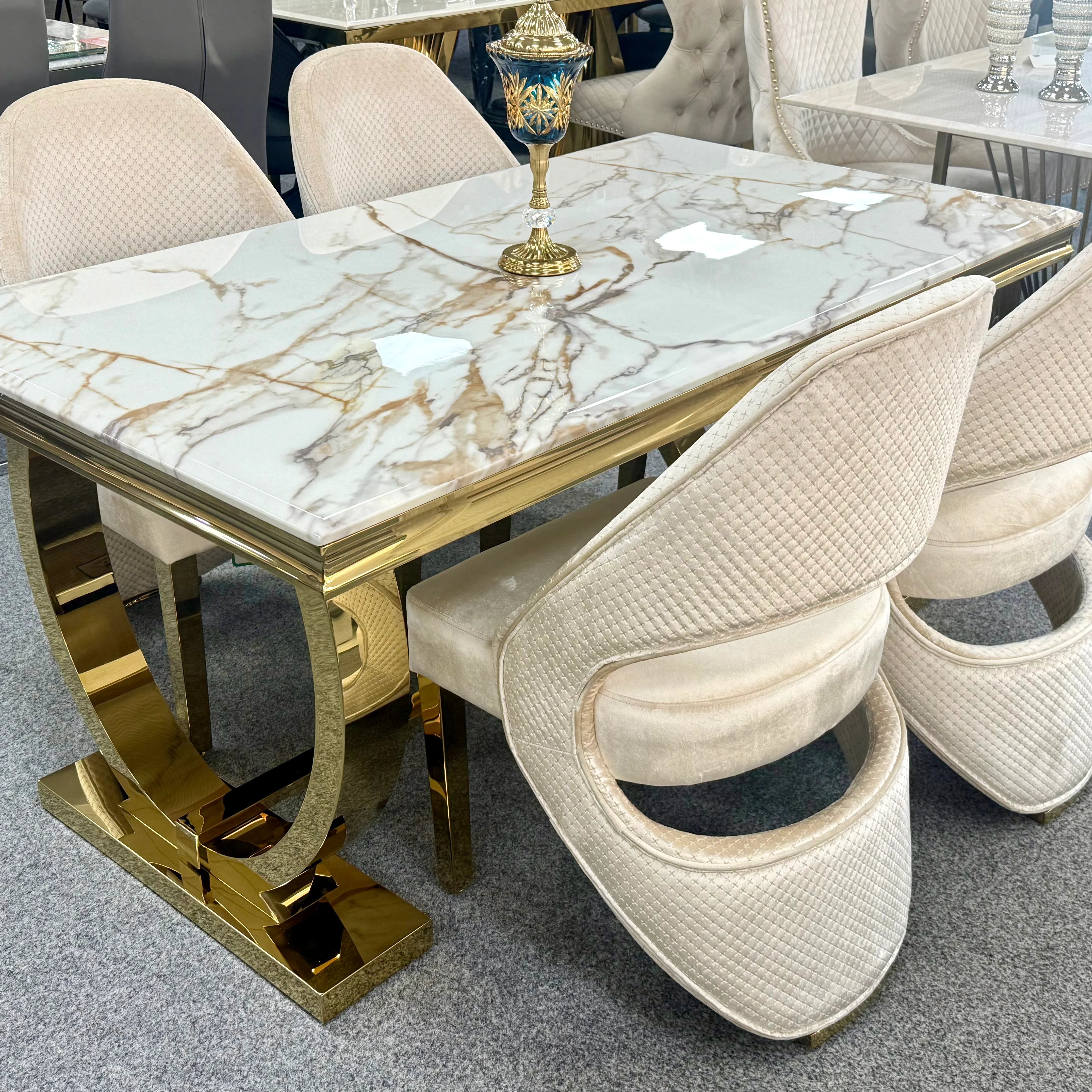 Ariana 180cm white and gold marble dining table with Santo chairs for sophisticated London dining rooms, combining high-gloss marble with a polished gold pedestal.