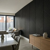 black acoustic slat wall panel measuring 240 × 60 cm with a modern herringbone design.