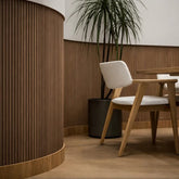 Flexible walnut slat wall panels installed on curved wall