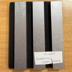 Close-up of metallic light grey slatted wall panel finish