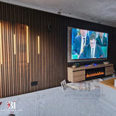 Walnut multi-width slatted media wall