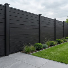 Black composite fence panels installed as a garden boundary