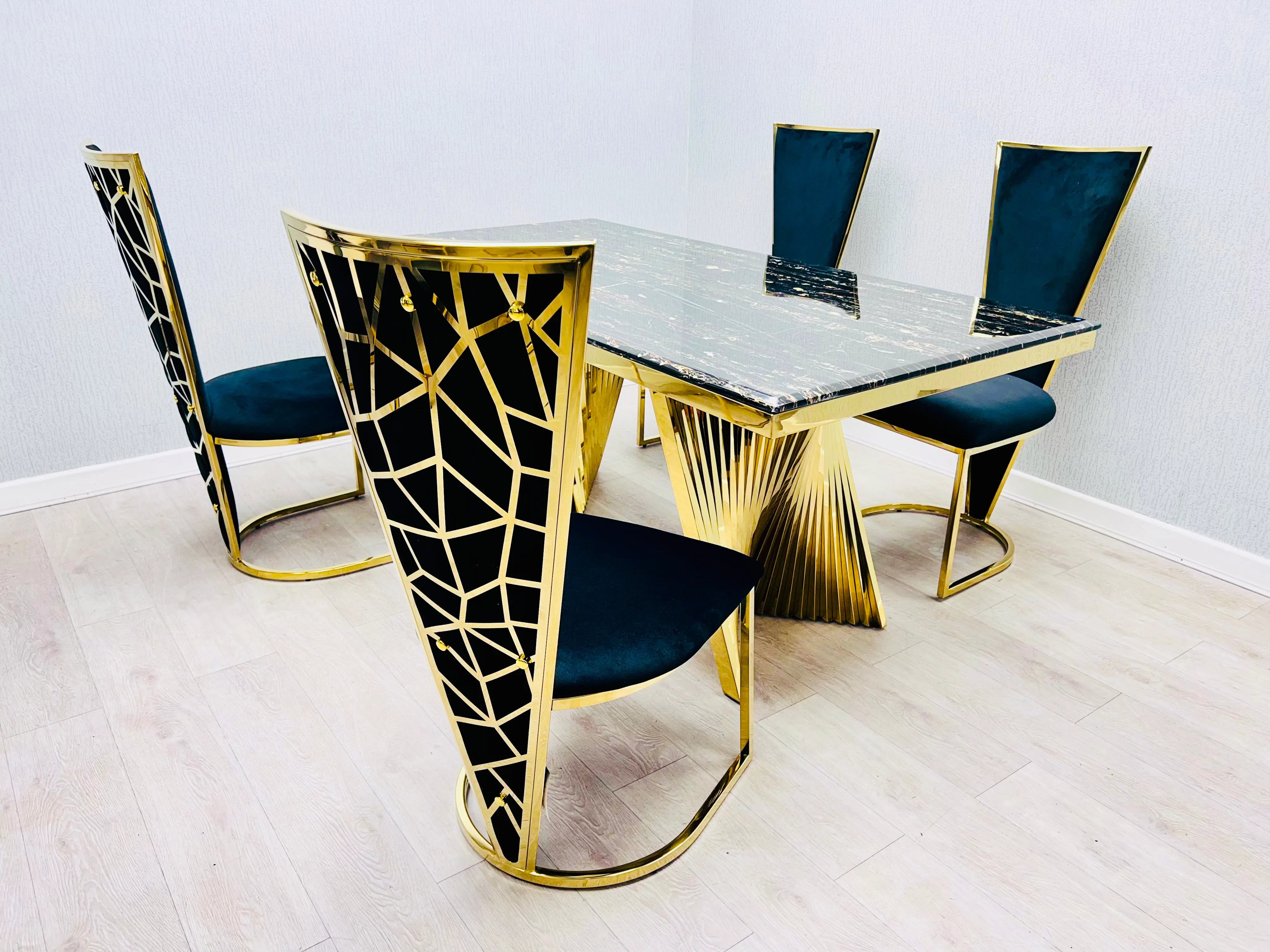 Ravello luxury dining suite featuring a geometric gold pedestal and comfortable Vienna seating, offering excellent value for contemporary Manchester homes.