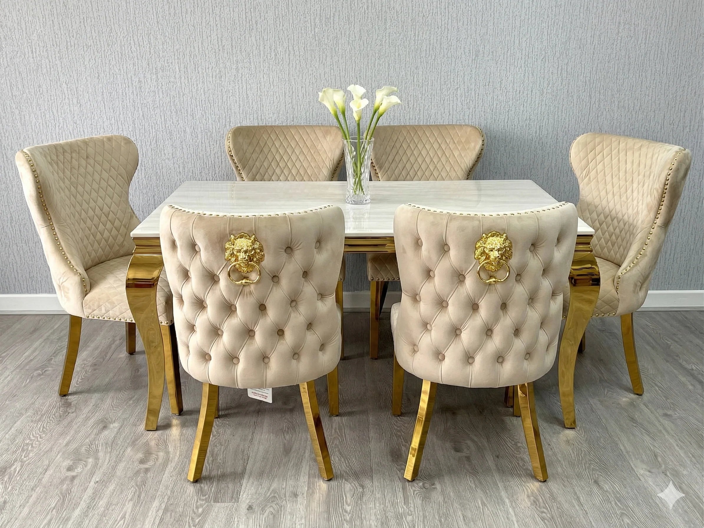 Valentino Gold Chairs paired with a cream marble dining table for an elegant luxury dining room