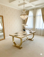 Premium Ariana marble dining table set with polished gold pedestal and Vegas chairs, designed for sophisticated UK homes seeking contemporary luxury furniture.
