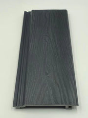 Black composite exterior wall panels with wood-grain texture