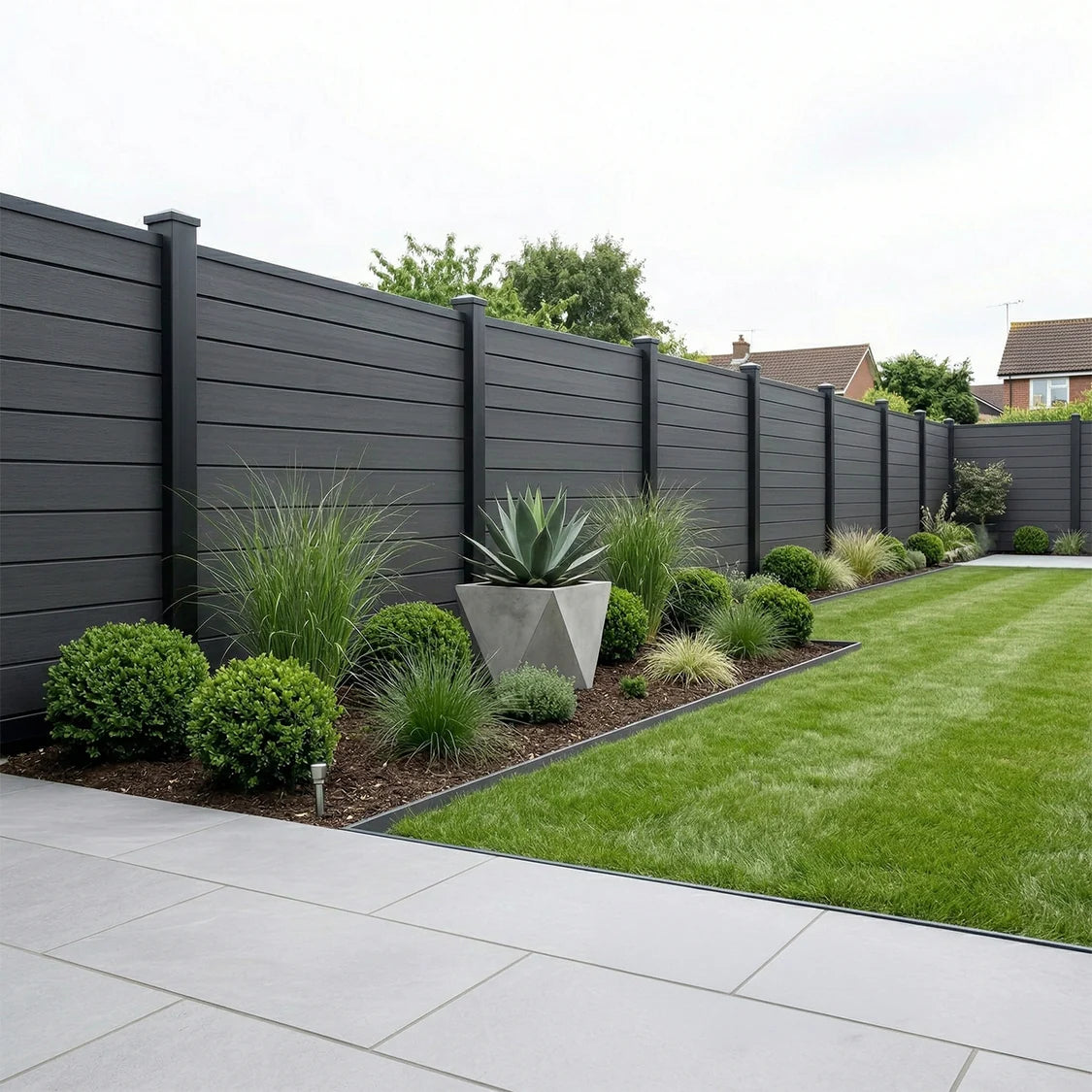 Black composite fence panels installed as a Outdoor home boundary