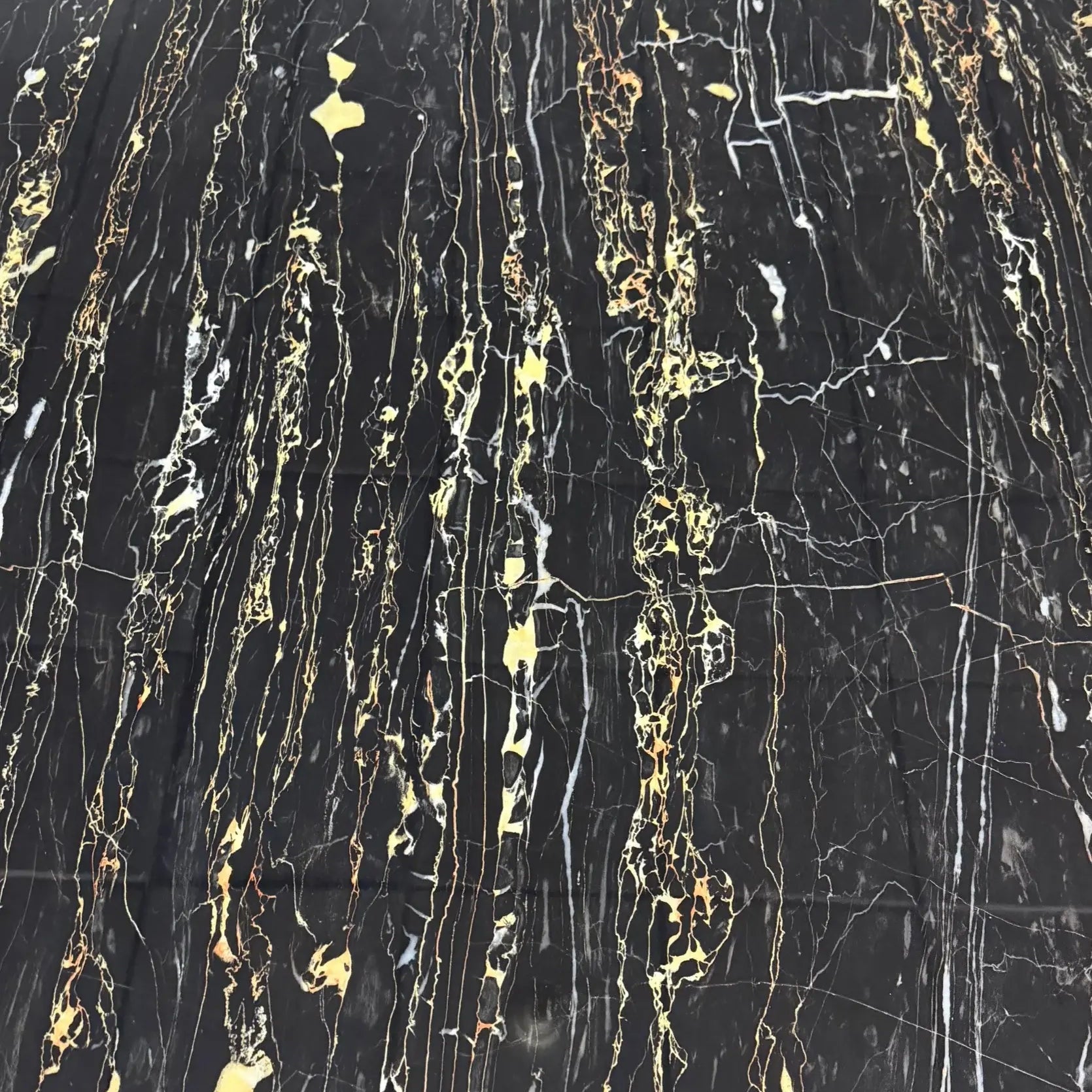 Close-up of the premium black and gold marble tabletop with a smooth polished finish.