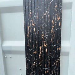 Black and gold WPC slatted wall panels with wood-effect finish