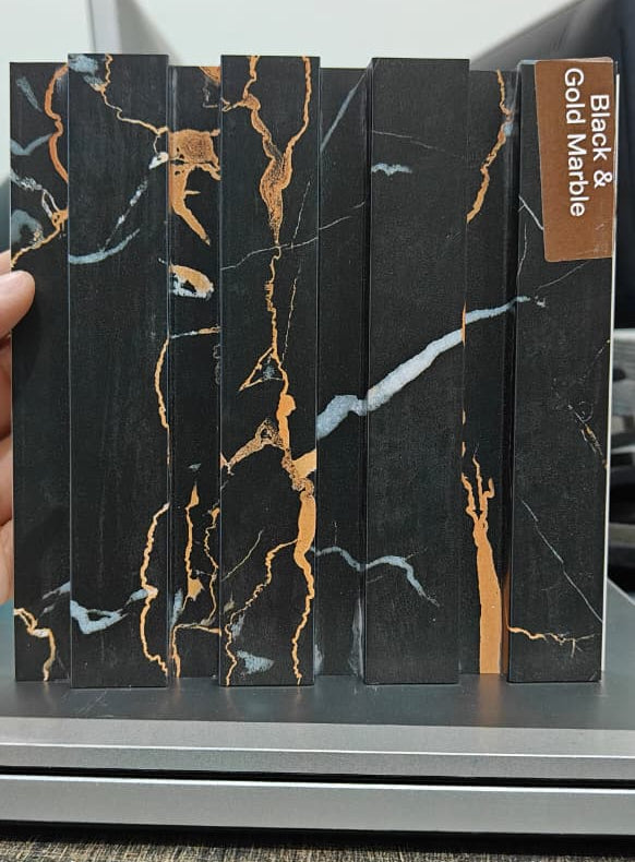 Close-up of black and gold WPC slatted wall panel finish