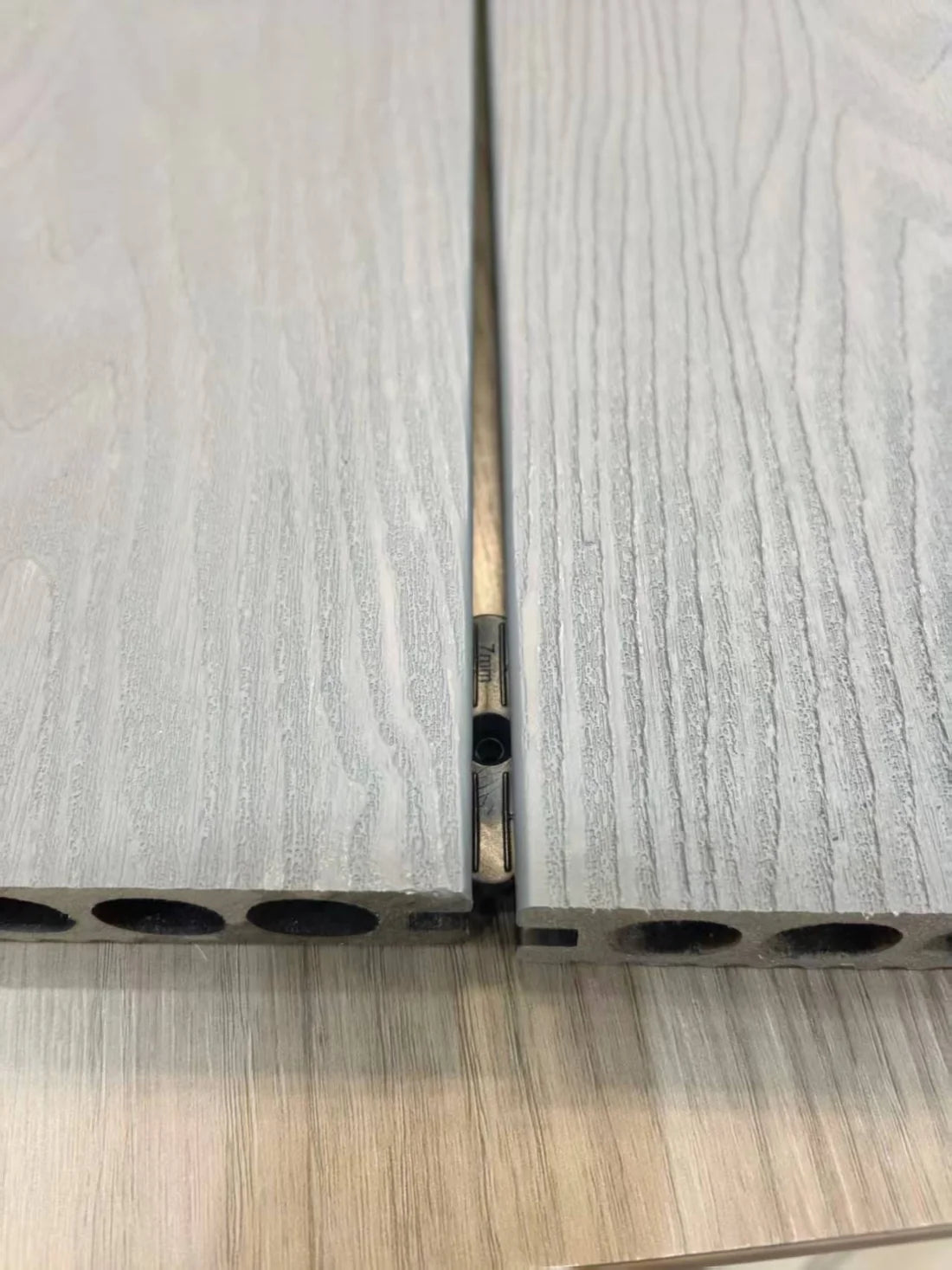 Composite decking fitting inserted into board groove