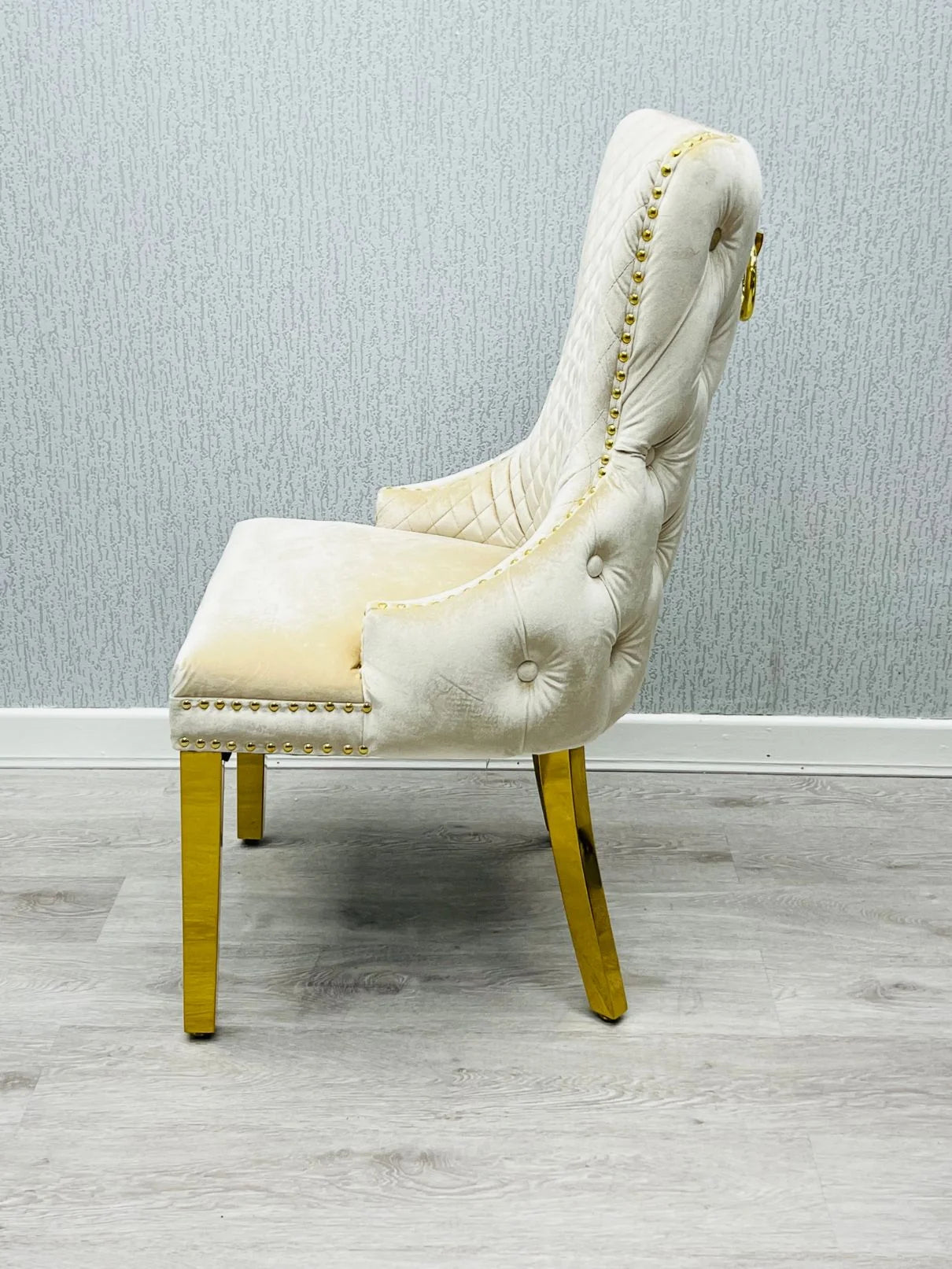 Contemporary luxury dining furniture combining cream marble, gold accents and statement chairs for Southampton homes