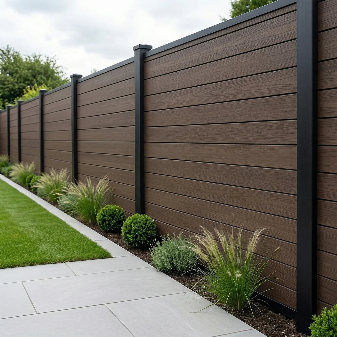 Dark brown composite fence panels installed in a modern garden