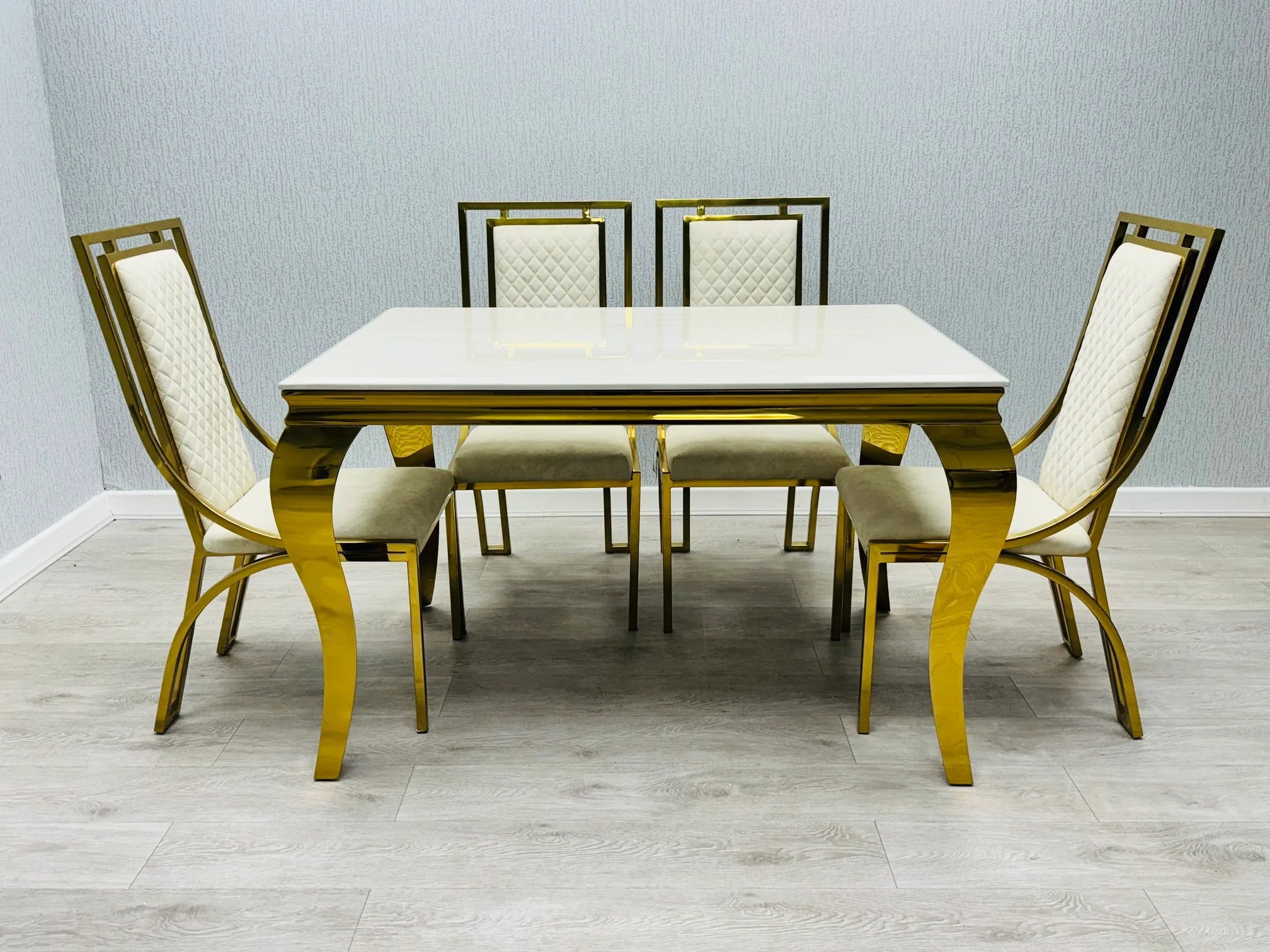 Contemporary cream marble dining set with luxury Windsor chairs, ideal for stylish homes and executive properties in Surrey.