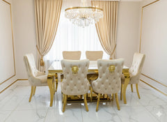 Luxury cream marble dining table with polished gold base and Victoria Lion Knocker Chairs for an elegant dining room