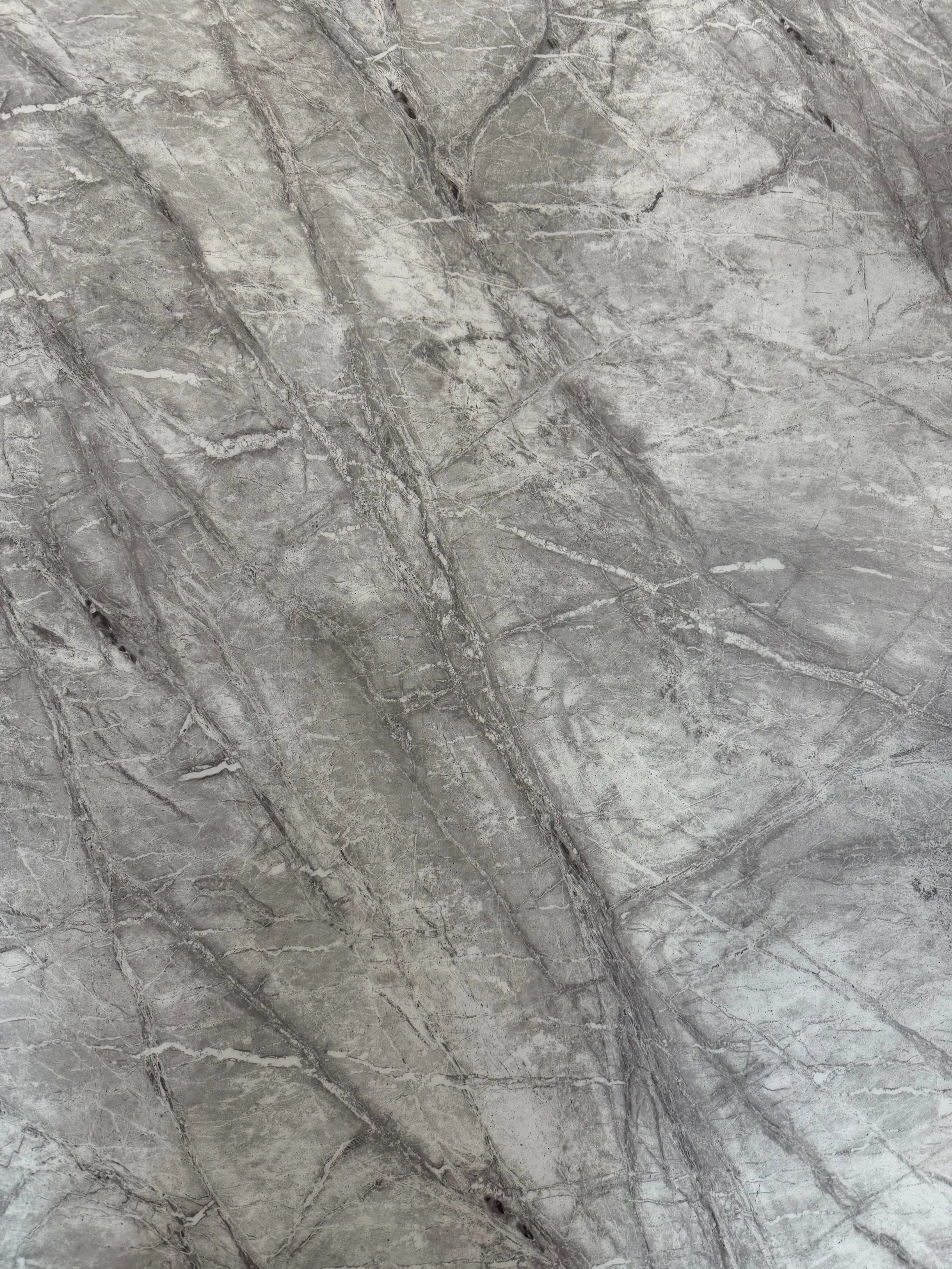 Close-up of Elina grey marble tabletop showing natural stone veining and a polished luxury finish