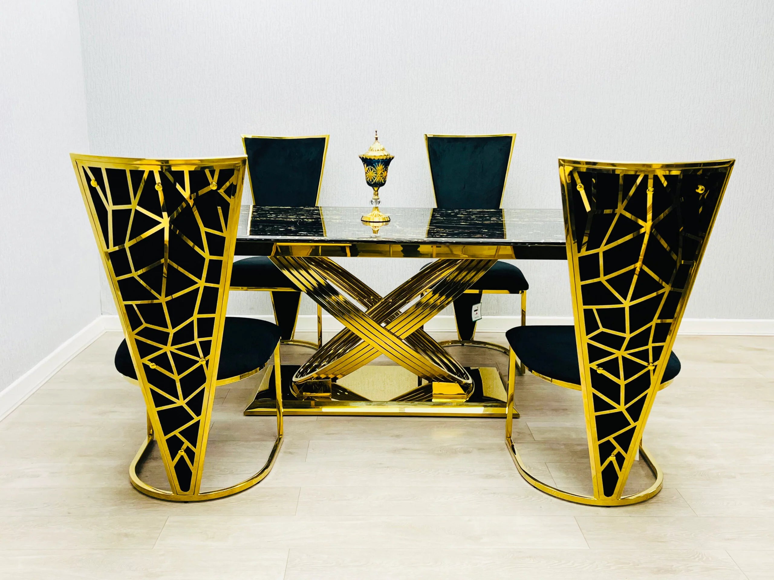 Contemporary cream marble dining table with distinctive gold pedestal design and Vienna chairs, adding premium quality and modern glamour to Glasgow interiors.
