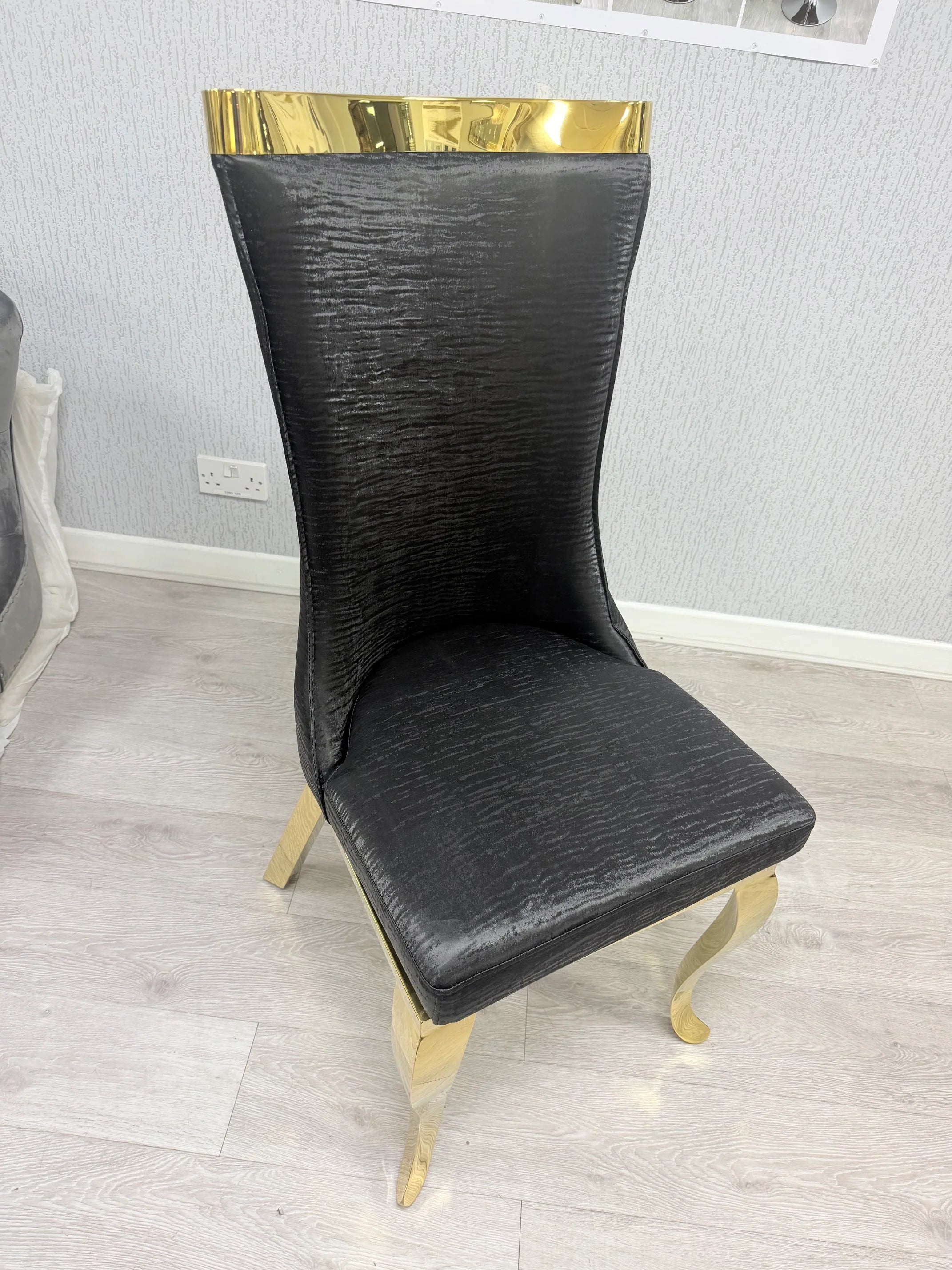 High-back Rocky dining chairs offering supportive seating and a refined designer appearance