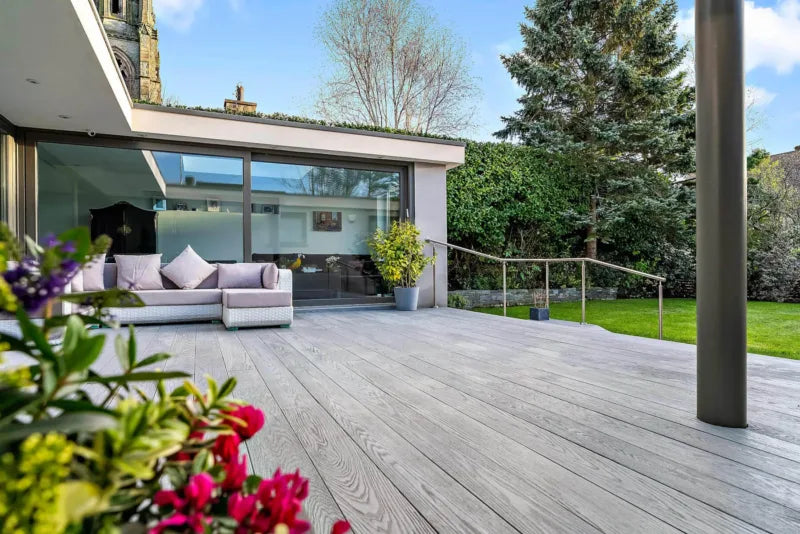Grey composite decking installed in a modern garden