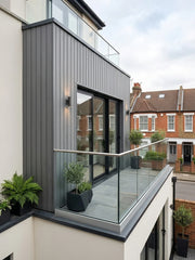 Grey composite exterior wall panels installed on a modern building
