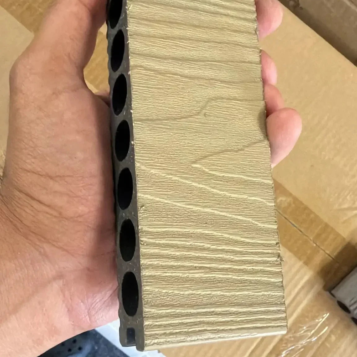 Close-up of khaki composite decking wood grain texture
