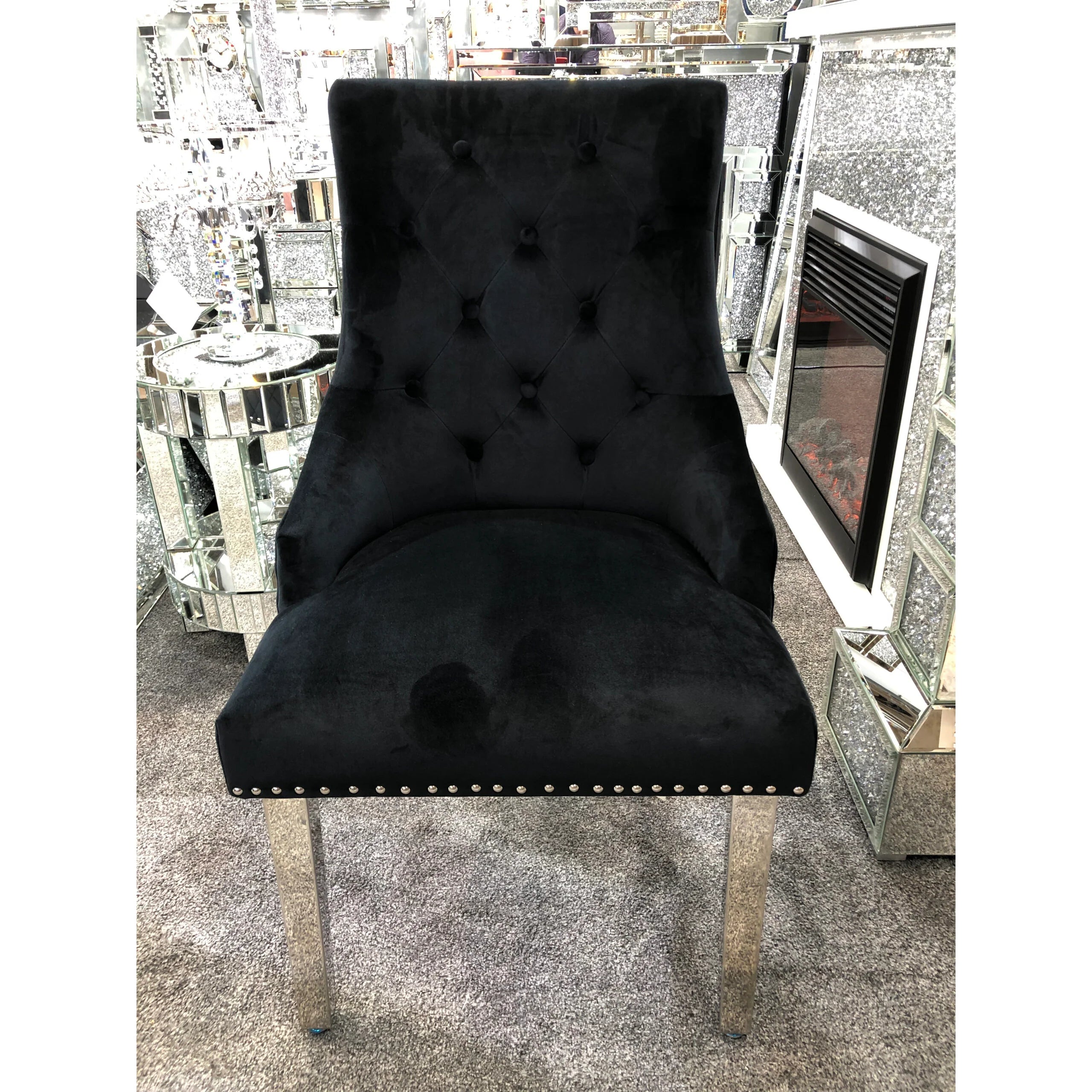 Lion Knocker velvet dining chairs paired with a polished grey marble table for an elegant contemporary interior