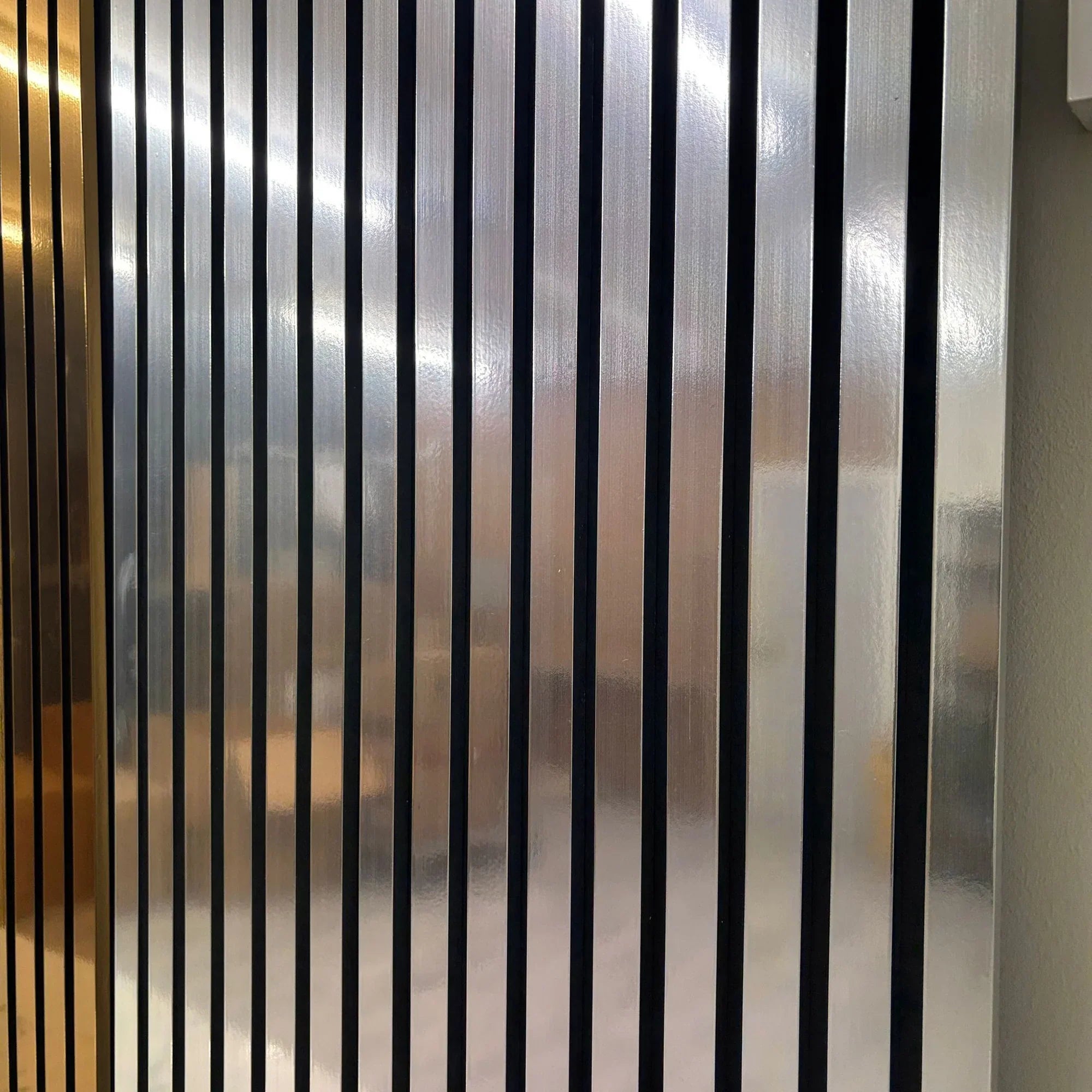 Close-up of Metallic Chrome slatted wall panel finish
