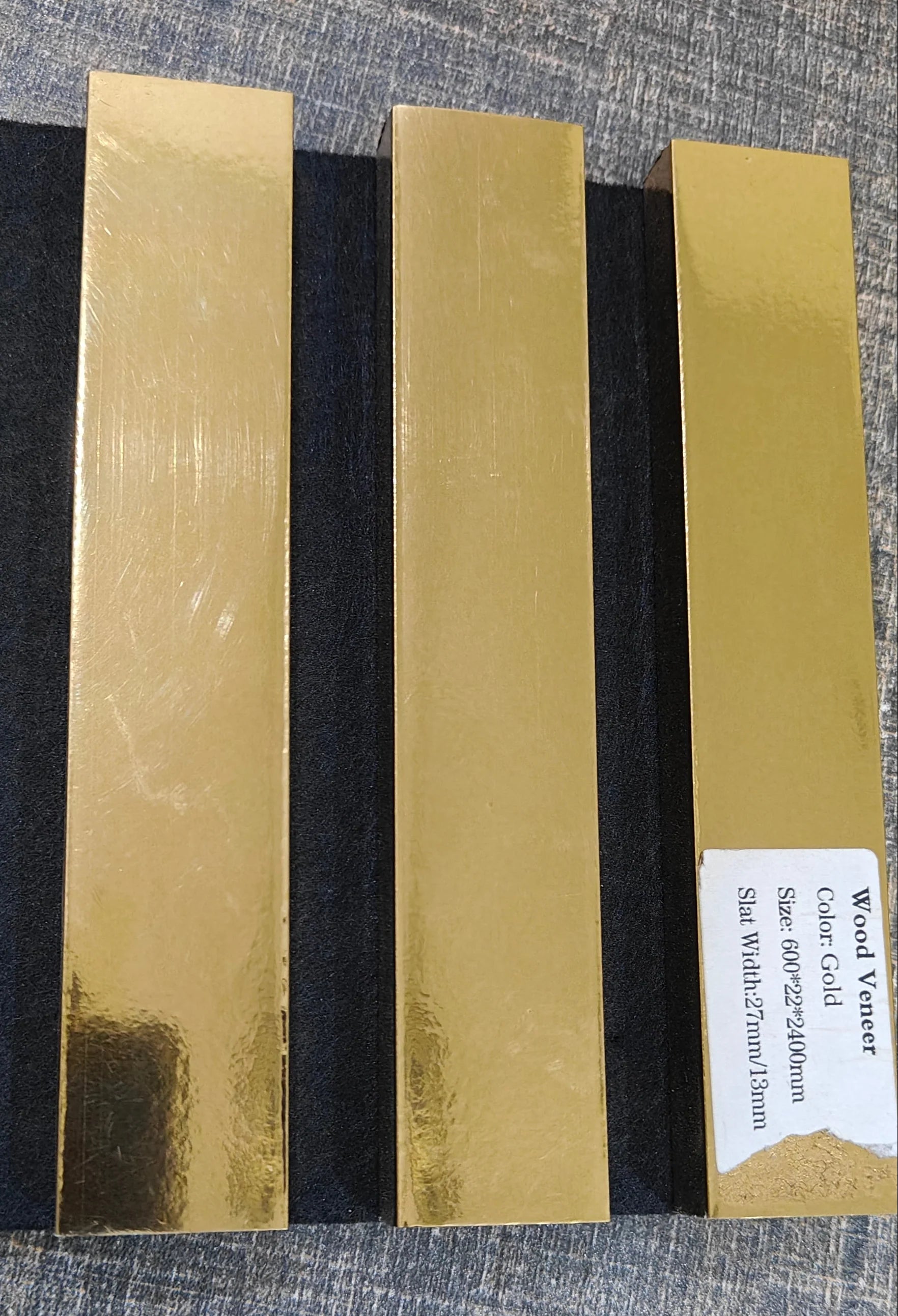 Close-up of Metallic Gold slatted wall panel finish