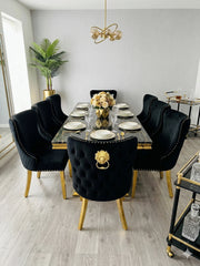 Modern luxury dining room table and chairs with a geometric gold pedestal and premium Valentino Gold seating