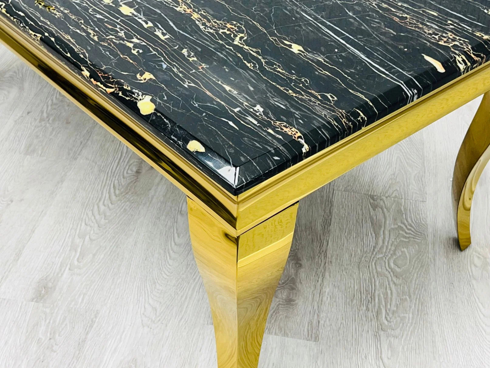 Luxury dining room inspiration for Liverpool homes featuring gold marble detailing, elegant upholstered chairs, and a dramatic contemporary aesthetic.