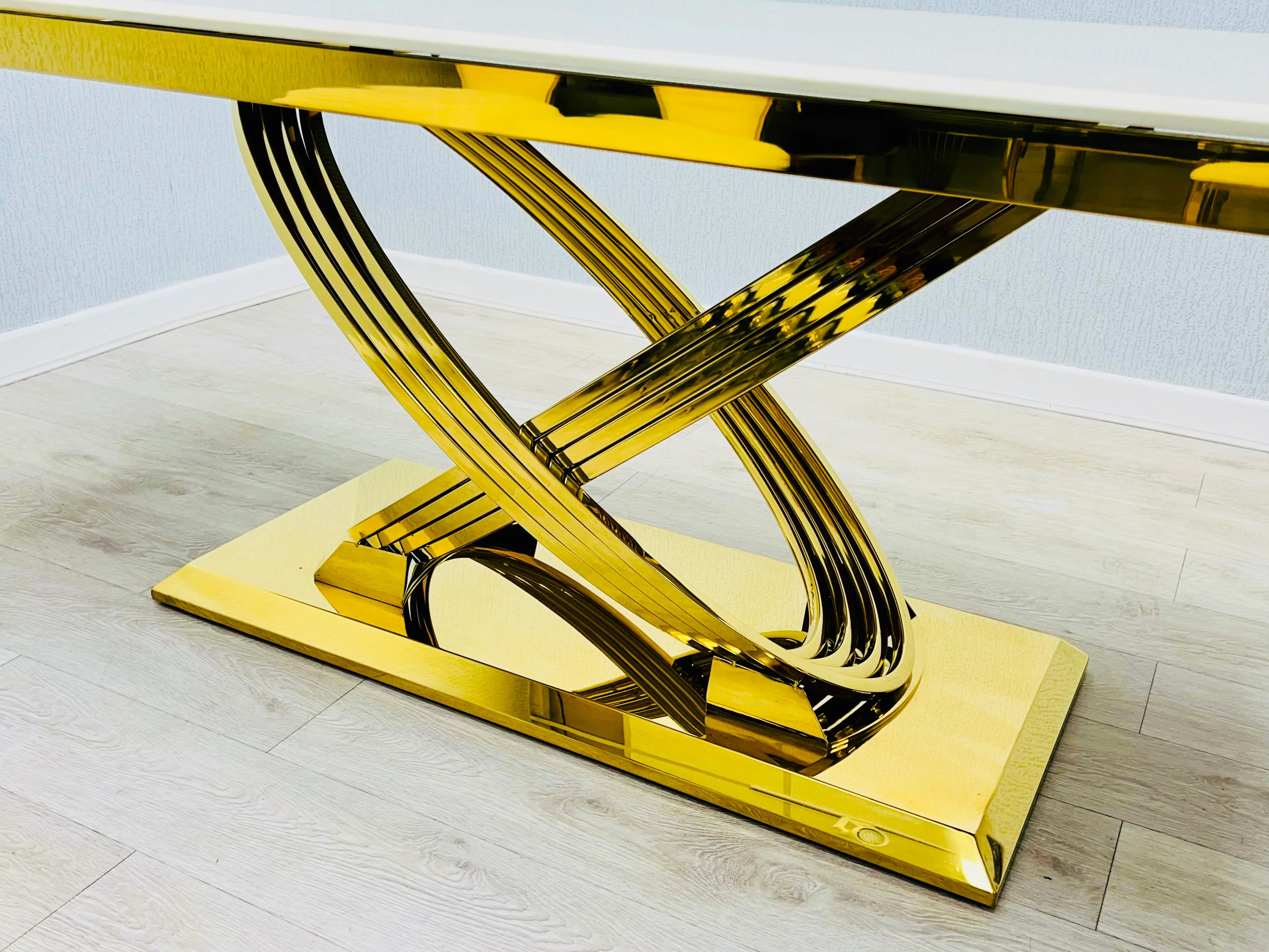 Contemporary Ravello black and gold dining table with sculptural pedestal design and stylish Lasco chairs, adding designer character to Coventry dining spaces without an excessive luxury price.