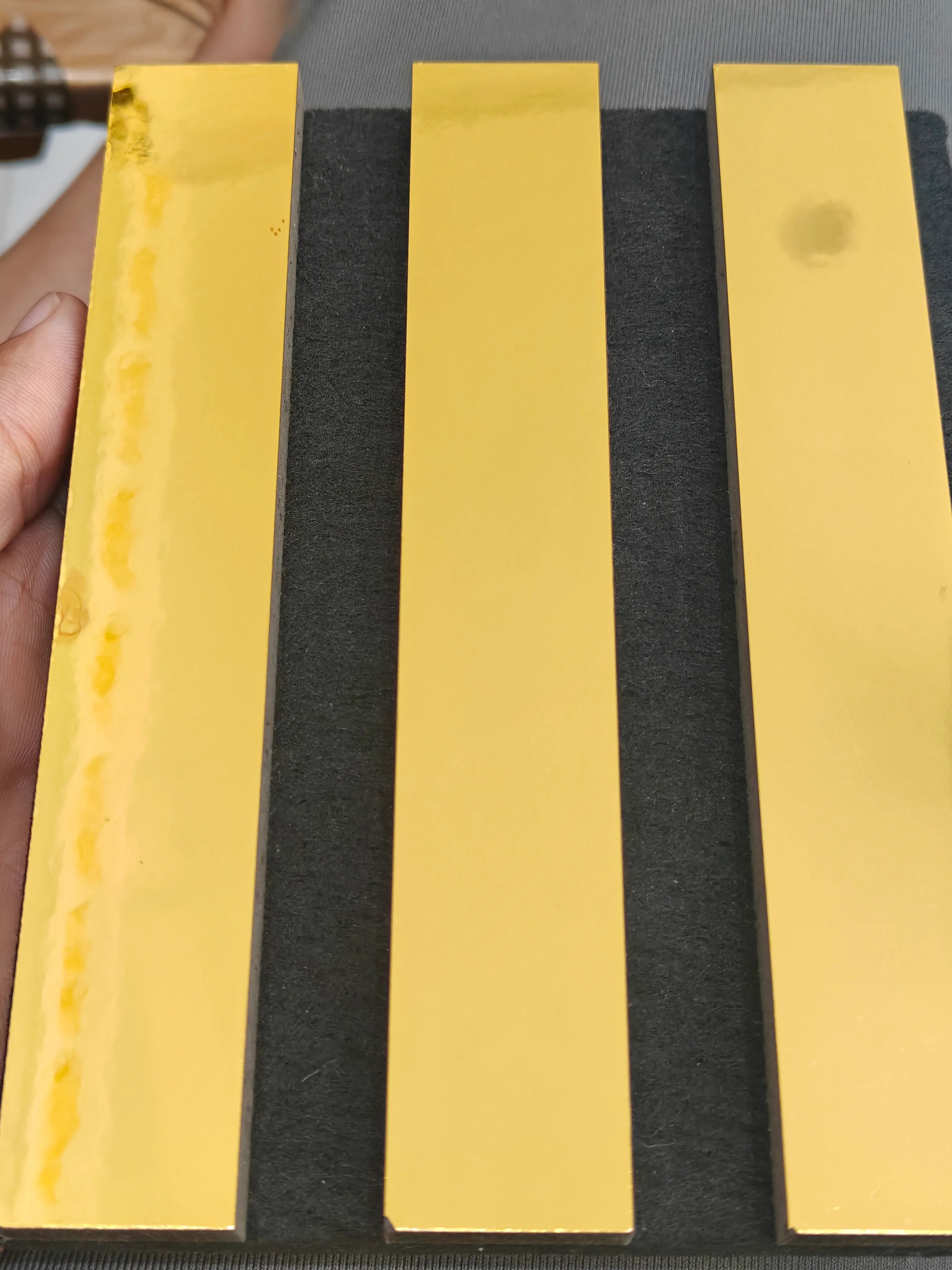 Shiny gold slatted HDF acoustic wall panel