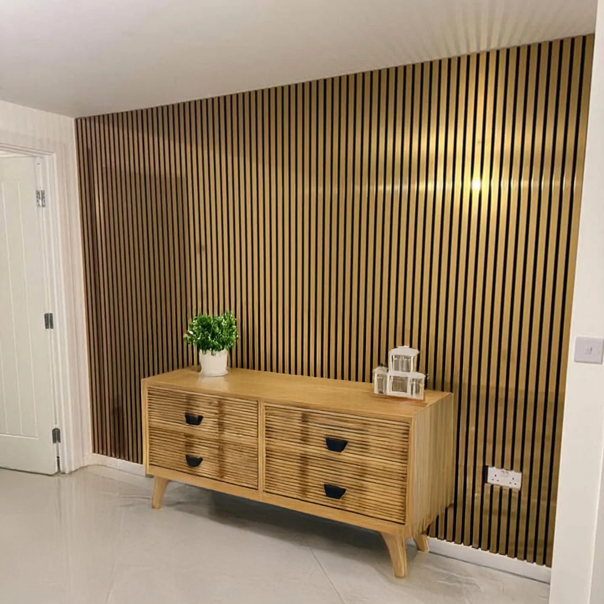 Gold sound-absorbing slatted wall panels for interior spaces