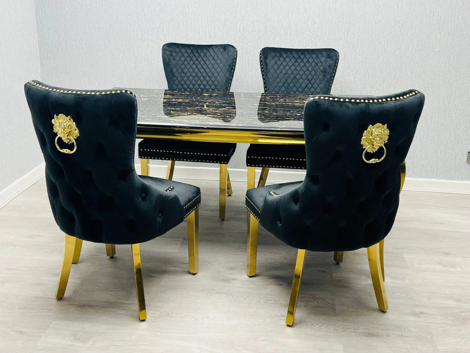 Add a touch of modern glamour interior design to Manchester homes with this black and gold marble dining set featuring designer lion knocker chairs.