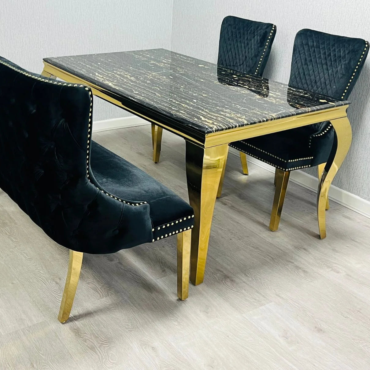 Black & Gold Marble Dining Table with Victoria Lion Knocker Chairs creating a luxury statement dining room for London penthouses, premium apartments, and elegant entertaining.