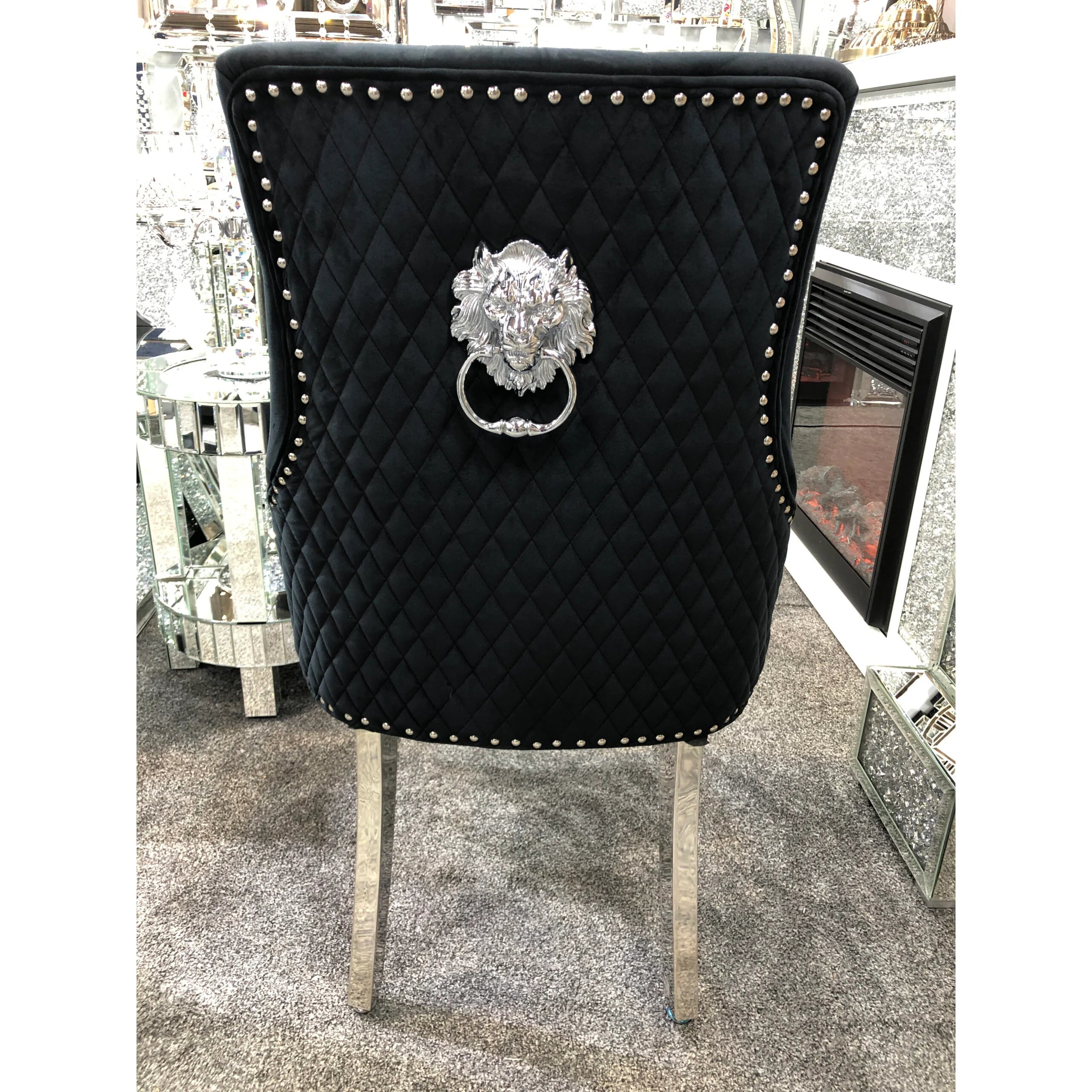 Statement Lion Knocker dining chairs creating a dramatic focal point in a modern luxury dining interior