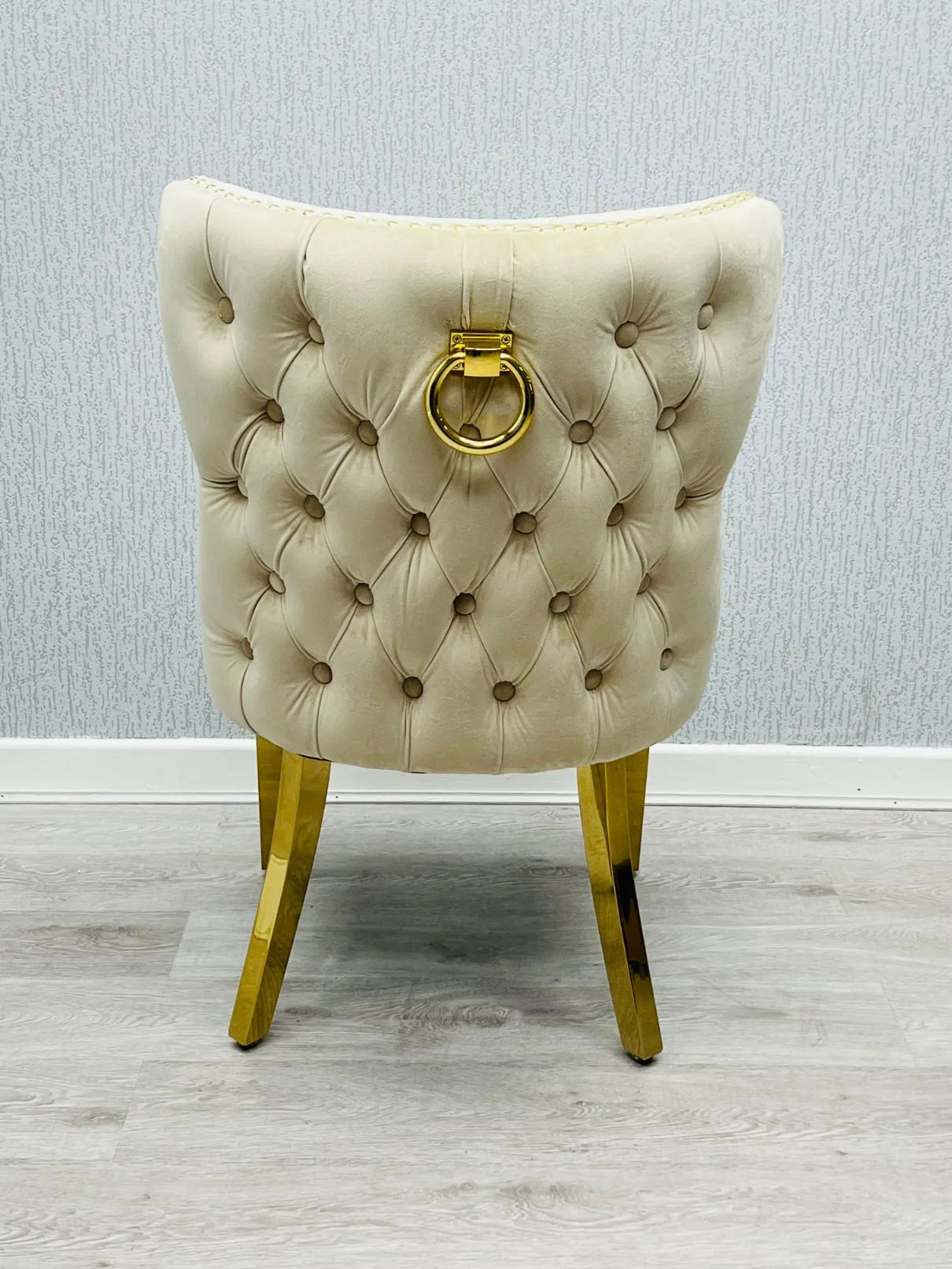 Valentino Gold Chairs paired with a cream marble dining table for an elegant luxury dining room