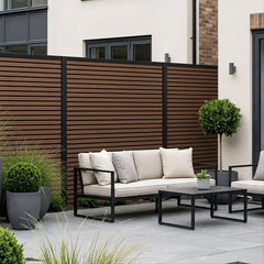 Walnut composite fence panels installed around a patio