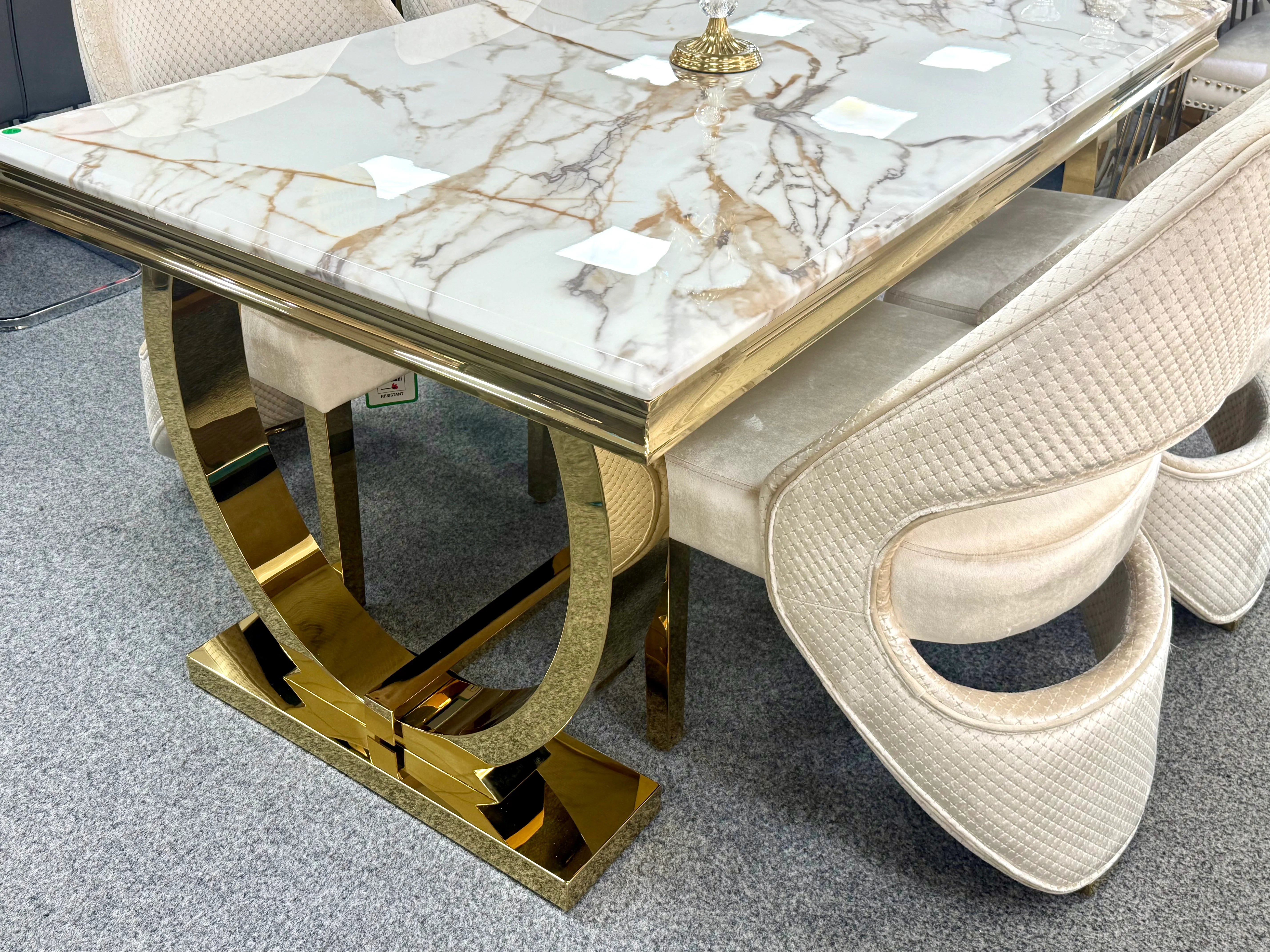 White and gold Ariana dining table with geometric stainless steel base and comfortable Santo chairs, ideal for Birmingham dining rooms and modern family meals.