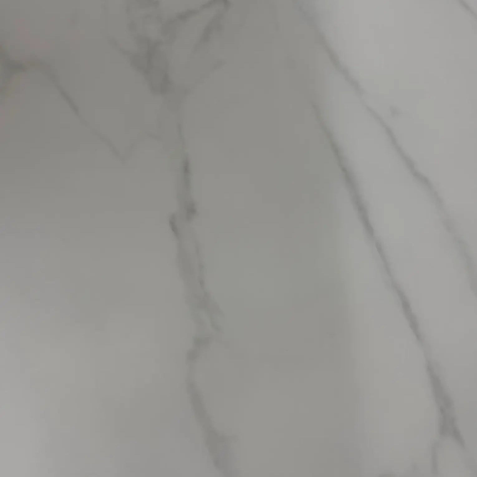 Close-up of the premium white marble tabletop with a smooth polished finish.